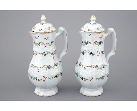 A fine pair of polychrome French faience jugs and cover, 18th C.         H: 19   cm Condition: One cover with a restored fini