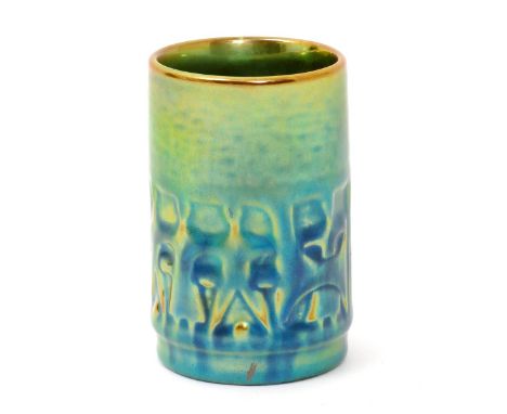 A Zsolnay Pecs pottery vase, cylindrical form, modelled with geometric figure panels, covered in a green and golden lustre gl