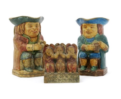 A Compton Potter's Art Guild toby jug,  modelled seated holding a frothing pint, glazed in colours, another similar and a boo