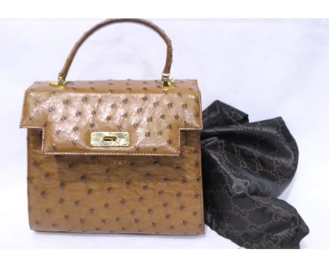 Ostrich leather handbag and a Gucci dust bag. Handbag appears in unused condition, no fading/ tears, some loose threads to Gu