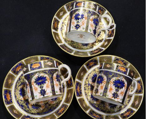 Three small Royal Crown Derby coffee cups and saucers in the 1128 pattern. One cup with star crack to base, and two with crac