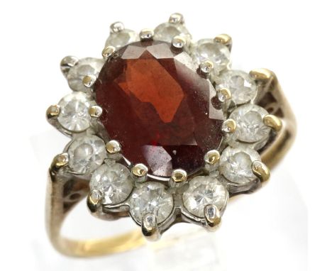 9ct gold ring set with a central garnet and CZ stones, size M, 2.1g. P&amp;P Group 1 (£14+VAT for the first lot and £1+VAT fo