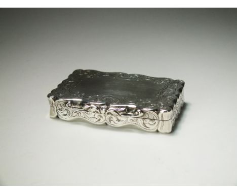 An early Victorian silver snuff box, William Dudley, Birmingham 1852, of shaped rectangular form with bright cut engraved dec