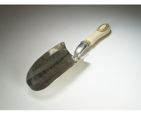 A Victorian silver presentation trowel, Walker & Hall, Birmingham 1872, the curved blade with engraved inscription and acorn 