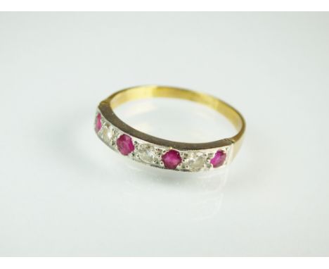 A seven stone ruby and diamond ring, designed as a row of four round mixed cut rubies interspersed with three brilliant cut d