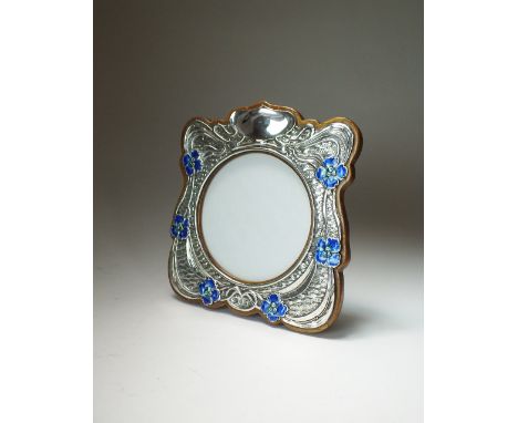 An Art Nouveau silver and enamel mounted photograph frame, Synyer & Beddoes, Birmingham 1904, of shaped square form with tend