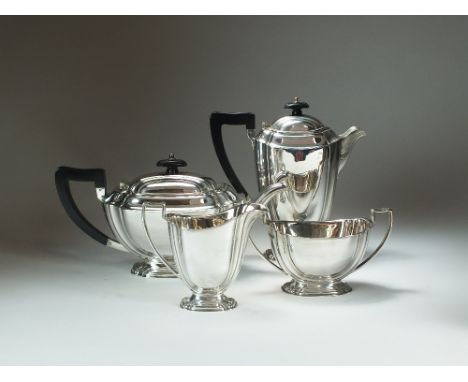 A four piece silver tea service, Atkin Brothers, Sheffield 1937 & 38, each piece of boat shaped form and raised on pedestal f