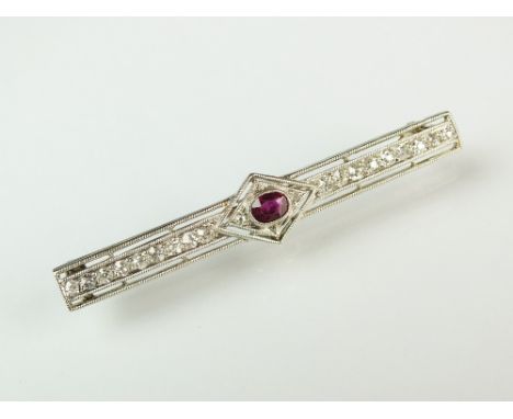 An Art Deco ruby and diamond bar brooch, designed as a central oval mixed cut ruby milligrain set in white metal to lozenge d