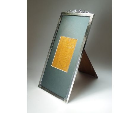 An Edwardian silver mounted photograph frame, Barnard Brothers, London 1909, of plain polished elongated rectangular form wit