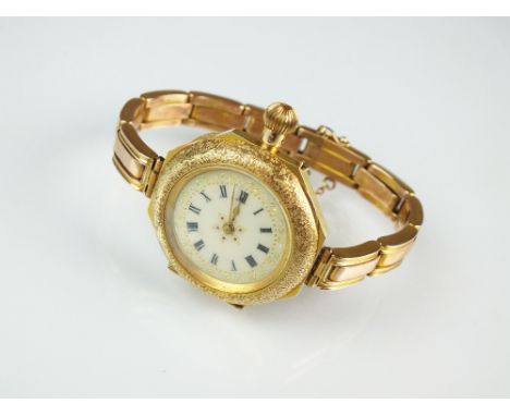 A lady's yellow metal cased wristwatch, stamped '14k', the octagonal decorative case with circular enamel dial and Roman nume