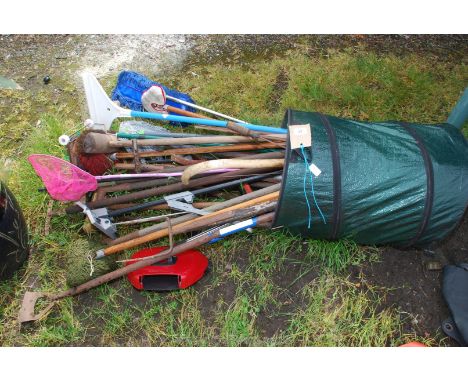 A large quantity of garden tools, brooms etc.