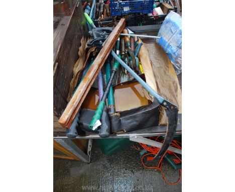 A quantity of garden tools and a scythe.