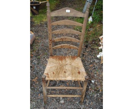 A ladder back string seated seat.