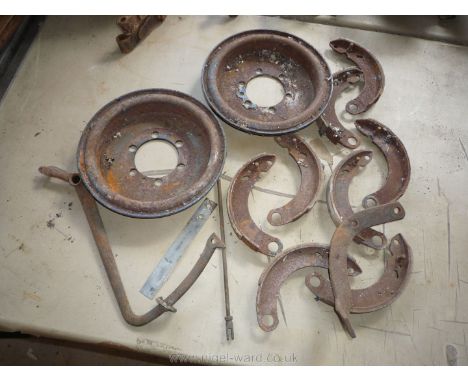 A quantity of Morris 8 spares including two brake drums, four pairs of brake shoes (some little worn), a brake lever, an adju