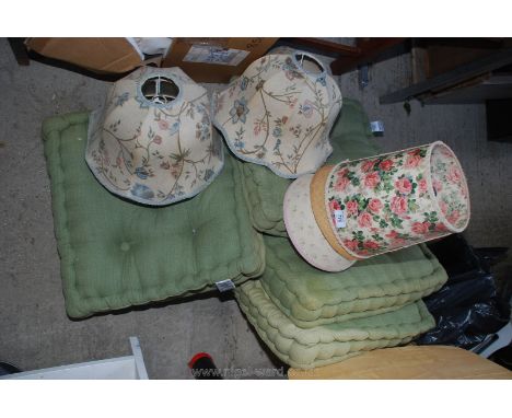 Four seat cushions and a selection of lamp shades.