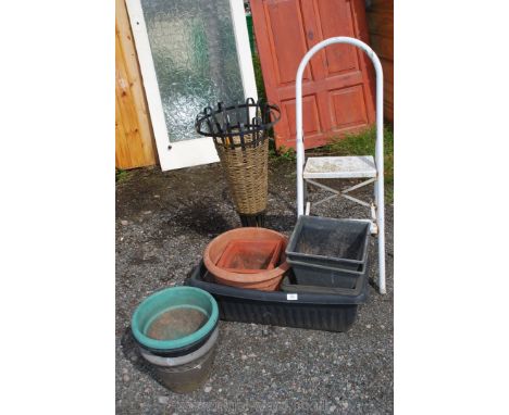 A quantity of plastic garden planters, step ladder and an umbrella stand.