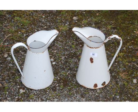 Two enamel metal jugs.