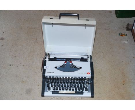 An "Olympia Traveller de luxe 8" portable typewriter.