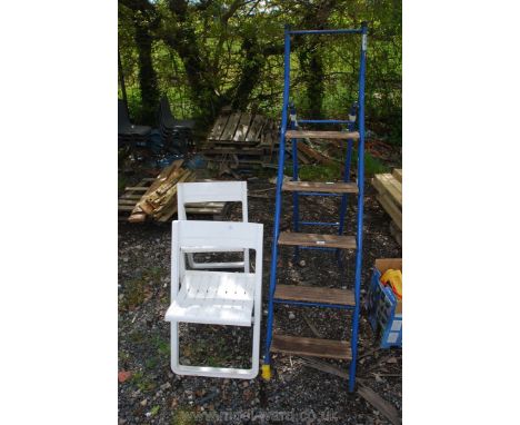 A metal step ladder and two folding chairs.
