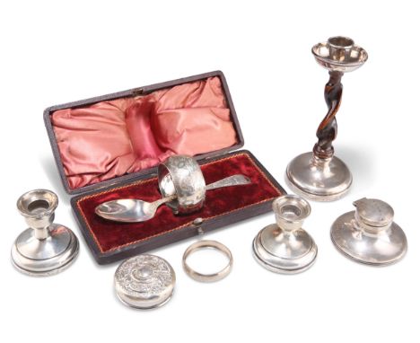 A GROUP OF SILVER, including a cased napkin ring and spoon, small capstan inkwell, pair of dwarf candlesticks, etc. (6 + case