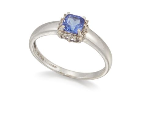 AN 18 CARAT WHITE GOLD TANZANITE AND DIAMOND CLUSTER RING, a cushion-cut tanzanite within a border of eight-cut diamonds. Hal