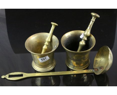 Two brass mortars with unassociated brass pestle, together with a large brass ladle (3) 