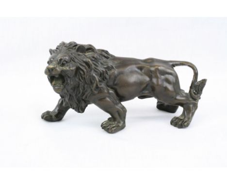 Filled Bronze model of a Lion with patinated finish, approx 15.5cm long