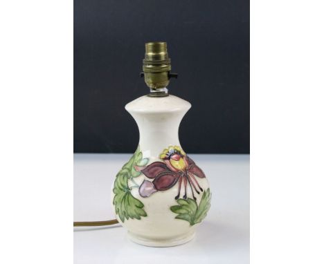 Contemporary cream ground Moorcroft lamp with tube line floral decoration