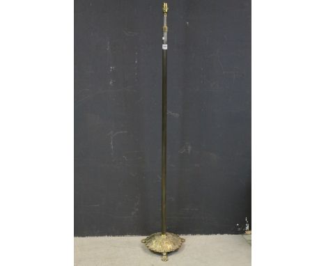 Antique brass standard lamp with reeded stem raised on a circular base with pad feet 