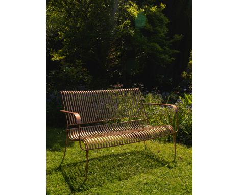 A compact yet stylish iron bench with an eye-catching copper finish. Expertly crafted, the curves of this bench cradle the si