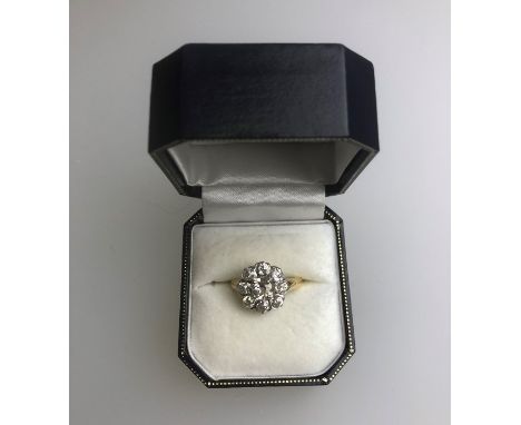 A diamond cluster ring, the central old cut diamond with eight smaller old cut diamonds around, yellow metal, unmarked and un