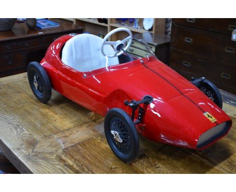 A Triang Vanwall Ferrari Grand Prix pedal car with white vinyl seat and perspex windscreen, open-spoked wheels with solid rub