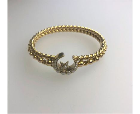 A Victorian yellow gold half-hinged rope twist bangle with concealed clasp, formed of solid cable link and bead decoration, w