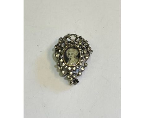 An Edwardian white metal and paste set pendant enclosing small Georgian portrait miniature watercolour of a lady, 3.5 long