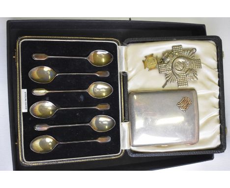 An Edwardian silver hip-pocket cigarette case mounted with gilt monogram HEB, Louis Willmott, London 1910 and a cased set of 