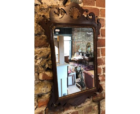 A 19th century mahogany fret cut wall mirror, the crest centred by a gilt shell deisgn 79 cm x 44 cm