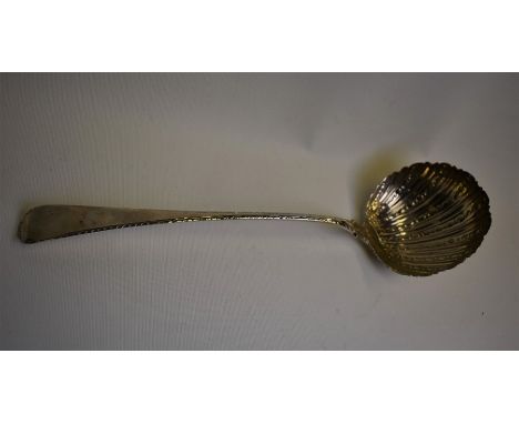 An early George III silver ladle with embossed shell bowl and feather-edge stem, maker's mark rubbed, London 1767, 5oz, 33 cm