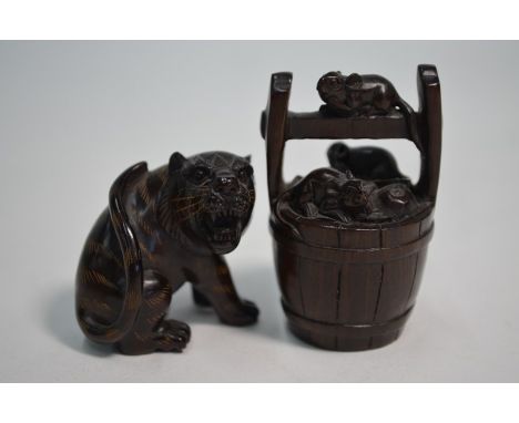 Two 20th century Japanese hardwood netsuke; three rats on a water bucket and a fierce seated tiger, both with mother of pearl