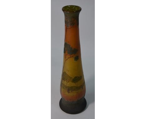 In the manner of Legras - An Art Nouveau French tall tapering vase enamelled with a wooded lakeland scene with sailing boats,