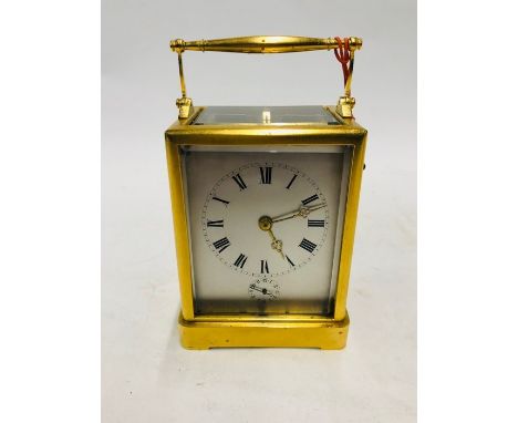 An antique French carriage clock in the manner of Paul Garnier, the gilded one piece case with two train counterwheel movemen