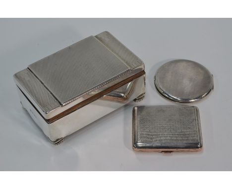 An Art Deco style silver cigarette-box with engine-turned decoration and bracket feet, William Neale Ltd., Birmingham 1934, 1