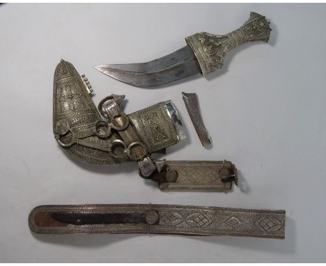 An Arab dagger Jambiya, the low-grade silver hilt, scabbard and belt richly decorated with wire filigree and beads, 33cm, c/w