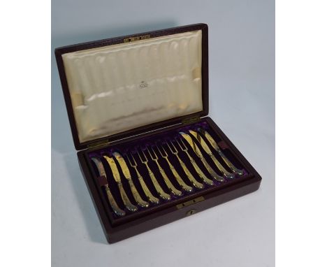 A Victorian Asprey burgundy morocco-bound case, fitted with a set of twelve silver gilt triffid teaspoons with engraved stems