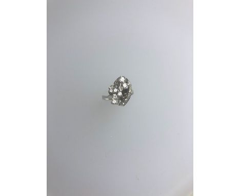 A contemporary stylised diamond cluster ring, white metal set stamped 750, diamonds approx 0.40 ct total weight, size L, appr