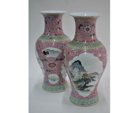 A pair of 20th century Chinese porcelain famille rose vases of baluster form with flared necks, finely painted with mountaino