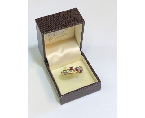 A French yellow metal ring formed of three part conjoined hoops, set square rubies and pave set diamonds, stamped 750, size X