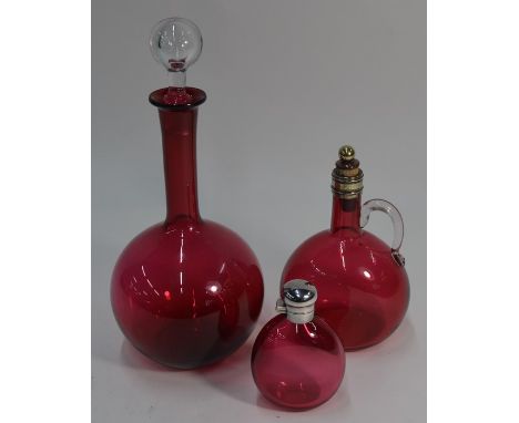 Three items of 19th century cranberry glass - A spherical decanter with long neck and clear glass stopper, a flask with clear