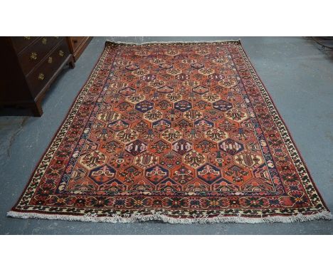 A Persian Baktiari carpet, the all-over diamond tile design in colours, 305 cm x 203 cm