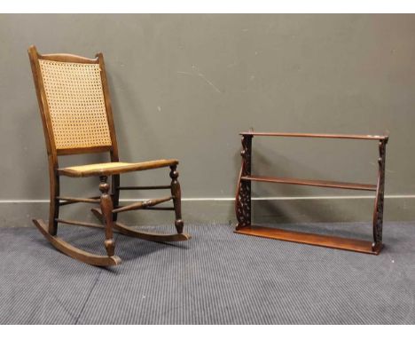 An oak rocking chair with reeded splat and seat, together with a decorative hanging shelf with pierced foliate rails, 51cm hi