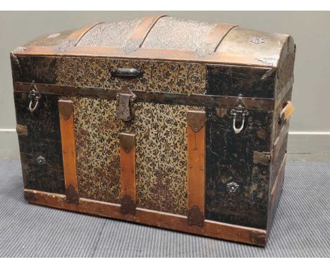 An dome top metal and wooden banded trunk, decorated with floral paper relief, with fitted tray to interior 61 x 87 x 49cm